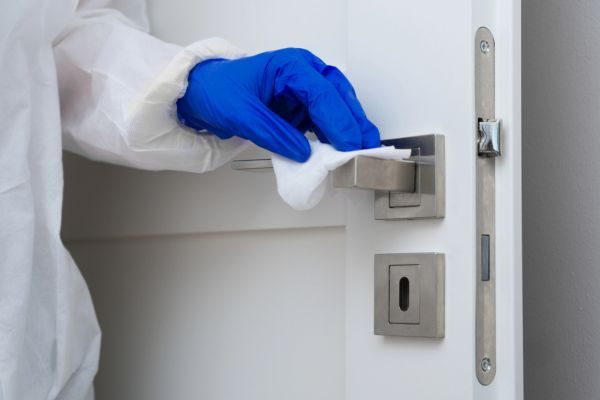 Suicide Cleanup crew member cleaning doorhandle in Chuluota, FL