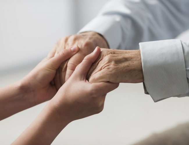 nurse-holding-senior-man-s-hands-for-sympathy